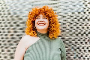 Beautiful woman with curly orange hair 